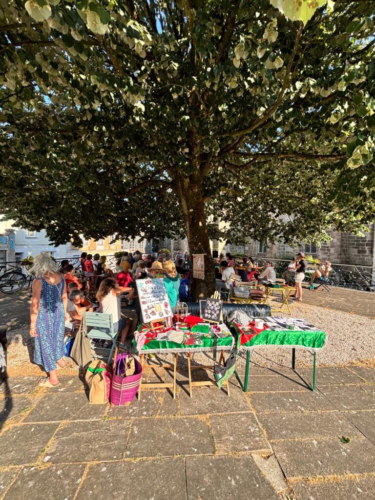 A solidarity stall at a gathering in Brittany, supported by volunteers and local partners